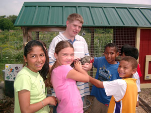 Youth petting a chicken.