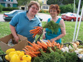 A couple ladies picking up their shares.